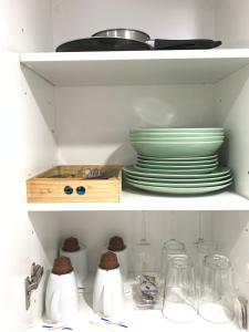 a white shelf with plates and dishes on it at Resitur Luxury Apartment 113 in Seville