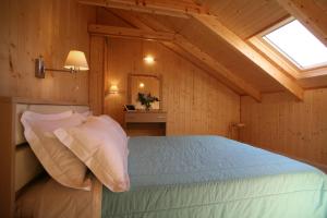 a bedroom with a bed in a room with a window at Grand TheoNi Boutique Hotel & Spa in Vasiliki