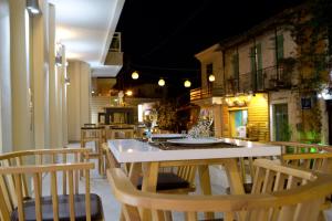 a kitchen with a table and chairs in a room at Grand TheoNi Boutique Hotel & Spa in Vasiliki
