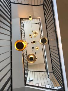 a mirror on a staircase with gold fixtures at Apartman Milíř - ADULTS ONLY in Bedřichov