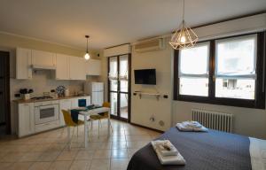 a kitchen with a bed and a table in a room at Casa Maggiolini - Stazione e Centro in Monza