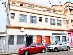two cars parked in front of a building at Hotel Fortaleza Manaus in Manaus