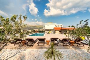 a patio with chairs and a swimming pool at Apartments Tina in Split