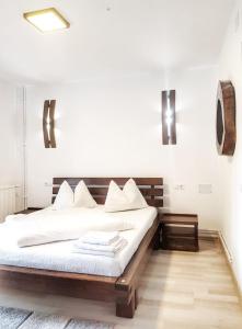 a bedroom with a bed and two lights on the wall at CABANA FRAM VÂRTOP in Nucet