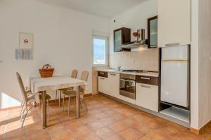 a kitchen with a table and a small table with chairs at Apartments Tina in Split