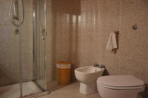 a bathroom with a toilet and a shower and a sink at Villa Venere Apartment in Realmonte