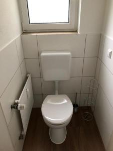 a small bathroom with a toilet and a window at Ferienwohnung Stadtflair in Daun +5 photos