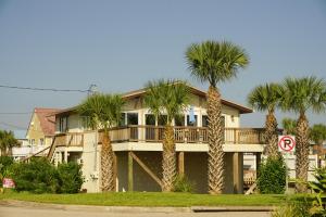 a house with palm trees in front of it at Oceanview Lodge - Saint Augustine in St. Augustine