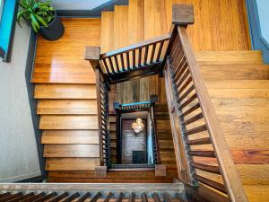 a wooden staircase with a wooden stair case at Artisan Downtown in De Land