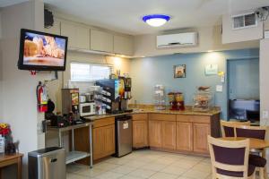 a kitchen with a television and a refrigerator at Townhouse Inn and Suites in Brawley