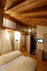 a hotel room with a bed and a tv at Chalet C'Est La Vie in Livigno