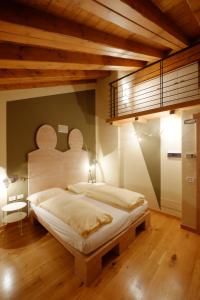 a bedroom with a bed and a night stand at Chalet C'Est La Vie in Livigno