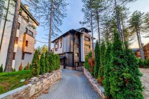 an exterior view of a house with a stone walkway at Apartment Dara in Zlatibor