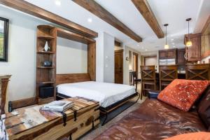 a bedroom with a bed and a couch at Villa Cortina 130 in Vail Village in Vail