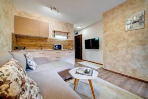 a living room with a couch and a table at apartman Dara 2 in Zlatibor