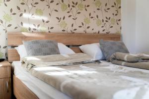 a bedroom with a bed with two pillows at apartman Dara 2 in Zlatibor