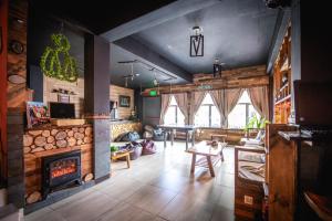 a living room with a fireplace and a table at Oshovia Hostel in Ushuaia