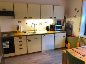 a kitchen with a sink and a microwave at Ferienwohnung Fischach in Fischach