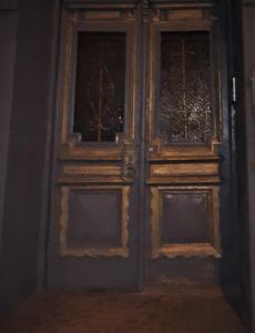 a wooden door with two windows in a room at Brickwall Tbilisi-Tbilisi vibe in Tbilisi City