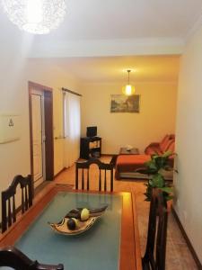a living room with a table with a bowl of fruit on it at Casa da Fátima, in Vila Chã