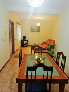 a dining room and living room with a table and chairs at Casa da Fátima, in Vila Chã