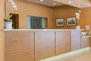 a reception desk in a lobby with wood paneling at Gateway Hotel Santa Monica in Los Angeles