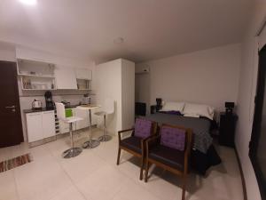 a bedroom with a bed and a table and chairs at Fado 103 in Colonia del Sacramento