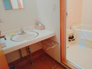 a bathroom with a white sink and a shower at 御宿しんしま in Matsuzaki +36 photos