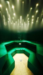 a large room with green lighting in a theater at Hotel Saalbacher Hof in Saalbach-Hinterglemm