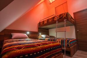 a bedroom with two bunk beds and an orange ceiling at The Traveler Hostel in Otavalo
