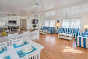 a living room with blue and white furniture and a kitchen at Twins Inn & Apartments in St Pete Beach