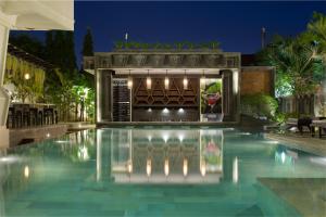 a swimming pool in a villa at night at Central Suite Residence in Siem Reap