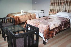 Llit o llits en una habitació de Harvest Moon Guest House