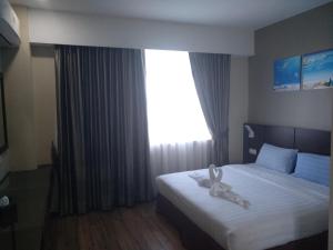 Letto o letti in una camera di Wave View Hotel