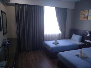 Letto o letti in una camera di Wave View Hotel