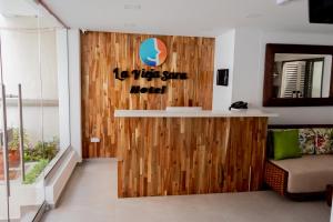 a lobby with a wooden wall with a sign on it at HOTEL LA VIEJA SARA RIOHACHA in Ríohacha