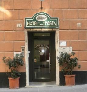 a hotel entrance with a sign on a building at Albergo Posta in Genoa