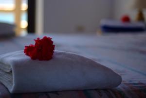 una flor roja encima de una toalla blanca en Tropicana Ocean Villas, en Boracay