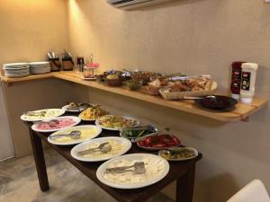 a table with many plates of food on it at Aleph HOTEL & SPA in Istanbul