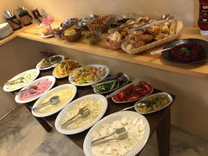 a table with many plates of food on it at Aleph HOTEL & SPA in Istanbul