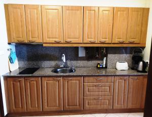 a kitchen with wooden cabinets and a sink at View Talay Residence 4 in Jomtien Beach