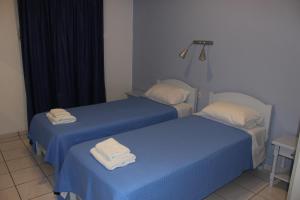 Cama ou camas em um quarto em Alvi Studios