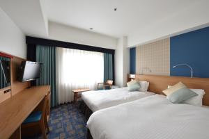 Letto o letti in una camera di Hotel Granvia Hiroshima
