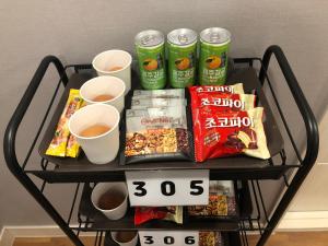 a black cart with drinks and snacks on it at Dawoo House 1 in Hongdae in Seoul