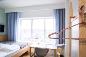 a hotel room with a bed and a window at Comwell Aarhus Dolce by Wyndham in Aarhus