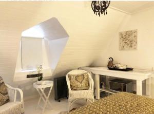 a room with a bed and a table and chairs at Drewry Lane in Howick +12 photos
