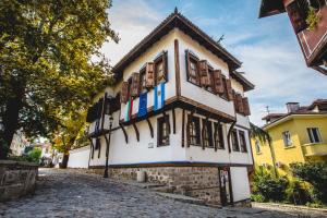 a building on the side of a cobblestone street at Plaza Hotel Plovdiv - Free Parking in Plovdiv