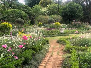 a garden with flowers and a brick path at Drewry Lane in Howick