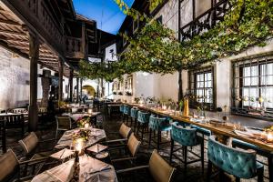 a restaurant with tables and chairs and vines at Romantik Hotel Zur Schwane in Volkach