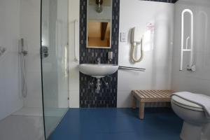 a bathroom with a sink and a toilet at Maria Giovanna Guest House in Marsalforn